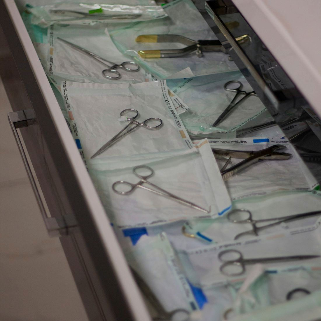 An open drawer of sealed sterile instrument packs.